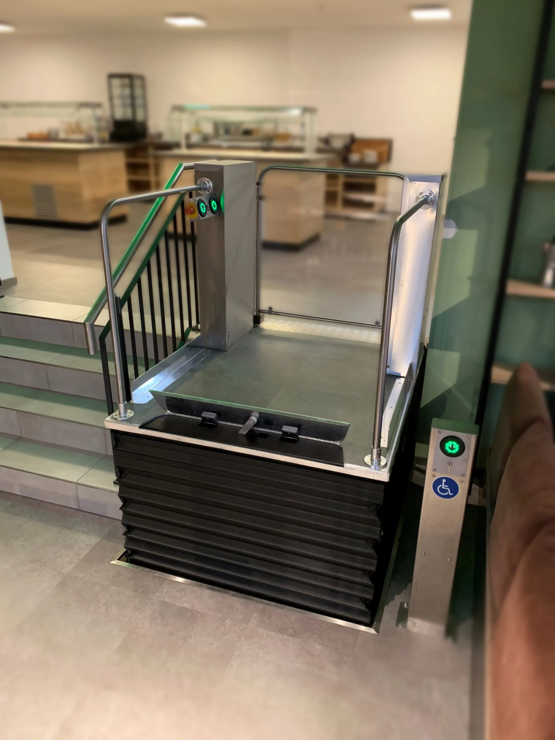 Hublift neben einer Treppe in einem Büro. Niedersachsen Lifte bietet qualitativ hochwertige Hublifte und ehrliche Beratung.